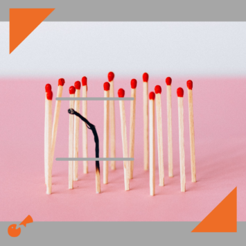 Group of matches standing upright with one burnt one leaning over
